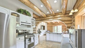 A modern kitchen with white cabinetry, stainless steel appliances, and a wooden ceiling. - Mountain Retreat w/ Deck: Ski, Soak, Golf & Hike! (Glenwood Springs)