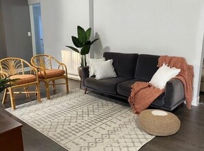 Relax in this stylish living room with a sofa, dining table, and comfortable seating area.