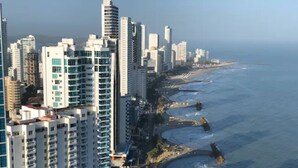 A coastal cityscape with high-rise buildings and a beach. - Luxurious & Spectacular View of Cartagena and the Caribbean Sea (Cartagena)