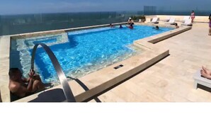 An infinity pool with clear blue water, surrounded by lounge chairs and a view of the ocean. - Luxurious & Spectacular View of Cartagena and the Caribbean Sea (Cartagena)