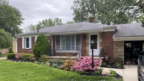 A single-story house with a brick exterior, a covered porch, and a garage. - Lorie house Avon ohio (Avon)