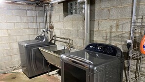 A laundry room with two washing machines and a large sink. - Lorie house Avon ohio (Avon)