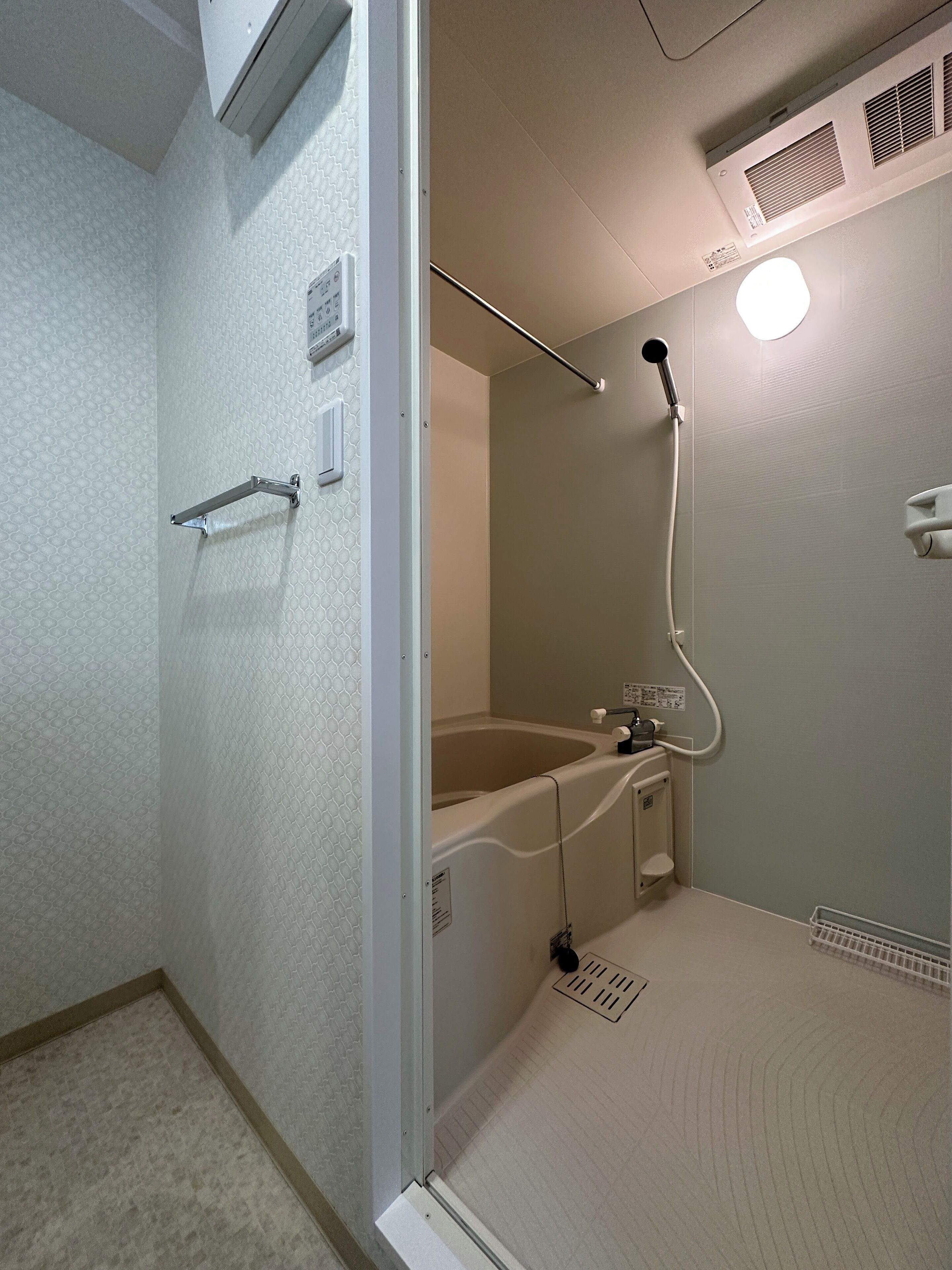 A bathroom with a shower, a bathtub, and a toilet.