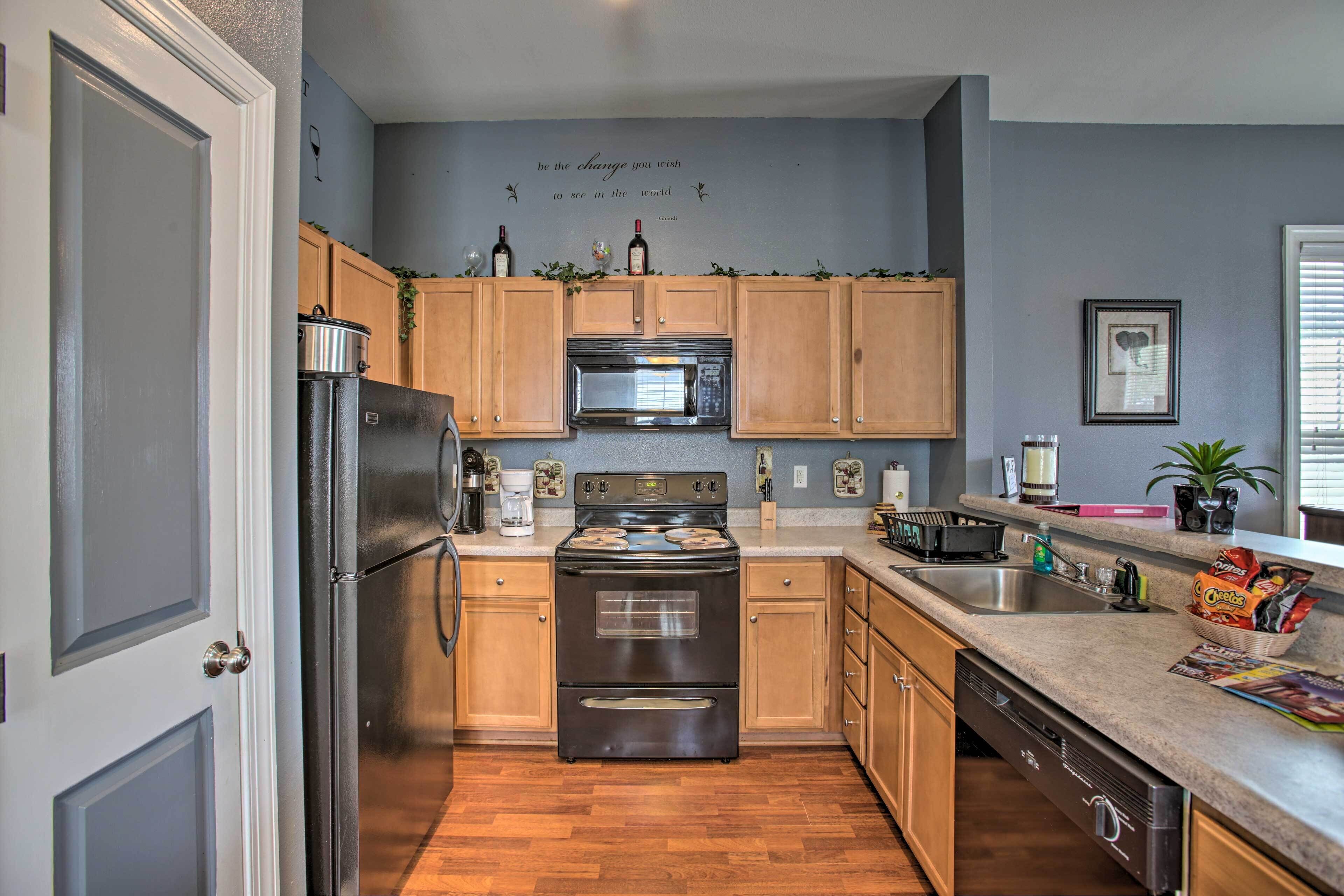 A kitchen with wooden cabinets, stainless steel appliances, and a granite countertop.