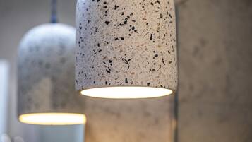 A close-up of a textured pendant light fixture with a warm glow.