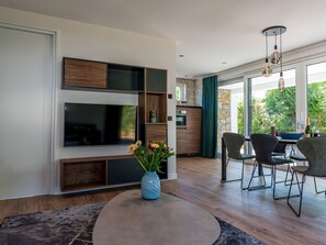 Enjoy a comfortable living space with a TV, dining area, and large window offering a view of the outdoors.