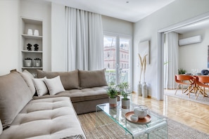 Relax in this stylish living room with a sofa, coffee table, and dining area.