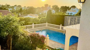 Relax by the pool surrounded by lush greenery and serene views.