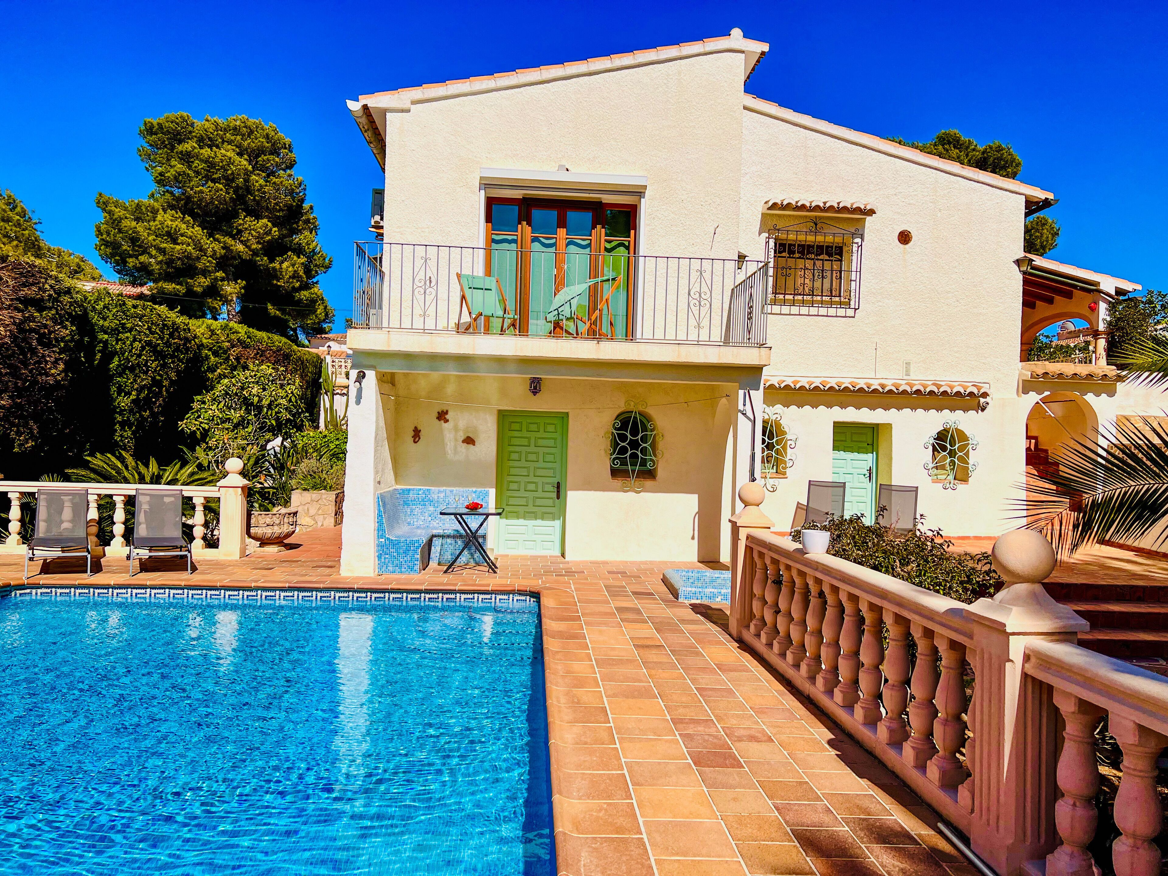 A two-story building with a swimming pool in front.