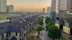 A residential area with traditional-style houses and modern high-rise buildings. - Royal Hotel II (Hanoi)