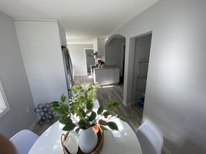 Enjoy meals and gatherings in this well-appointed space with a dining area, kitchen, and storage shelving.