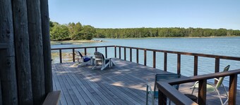 Cozy waterfront log cottage with huge outdoor living area.