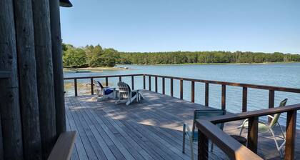 Cozy waterfront log cottage with huge outdoor living area.