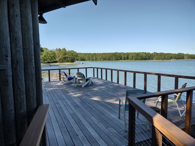 Cozy waterfront log cottage with huge outdoor living area.