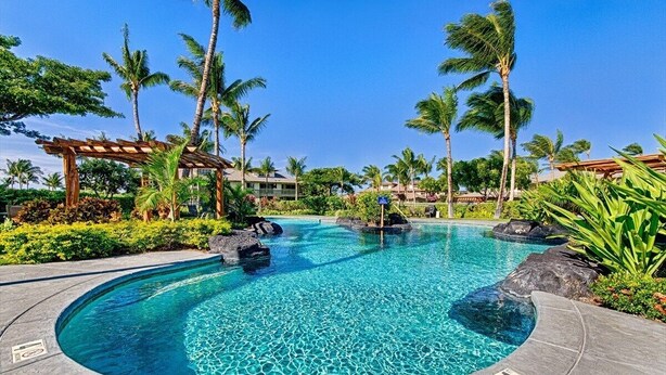 A pool with clear blue water, surrounded by palm trees and a pergola. - Sophisticated freshly remodeled 3bd+/3ba, two story villa w/ Private Beach club (Puako)