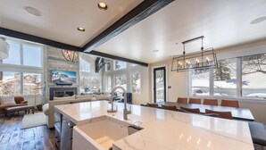 A modern kitchen with a large island, built-in appliances, and ample natural light from large windows. - Deer Valley luxury mountainside escape, outdoor seating, private hot tub, walk to hiking trails (Park City)