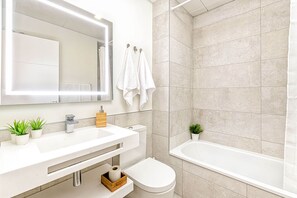 Bathtub, hair dryer, towels, soap