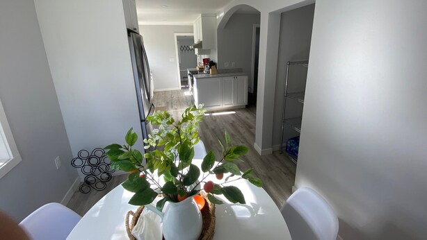 A modern kitchen with white cabinets, a built-in oven, and a stainless steel refrigerator. - 4th Street - Close to Downtown, Newly Renovated, Walk to Shopping, Dining, Drinks (Bend)
