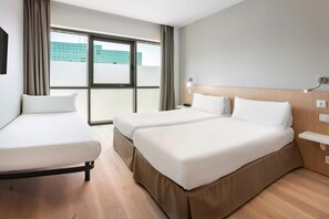 A hotel room with two beds, a wooden headboard, a nightstand, and a window with curtains. - B&B Hotel Barcelona Sant Cugat (SANT CUGAT DEL VALLES)