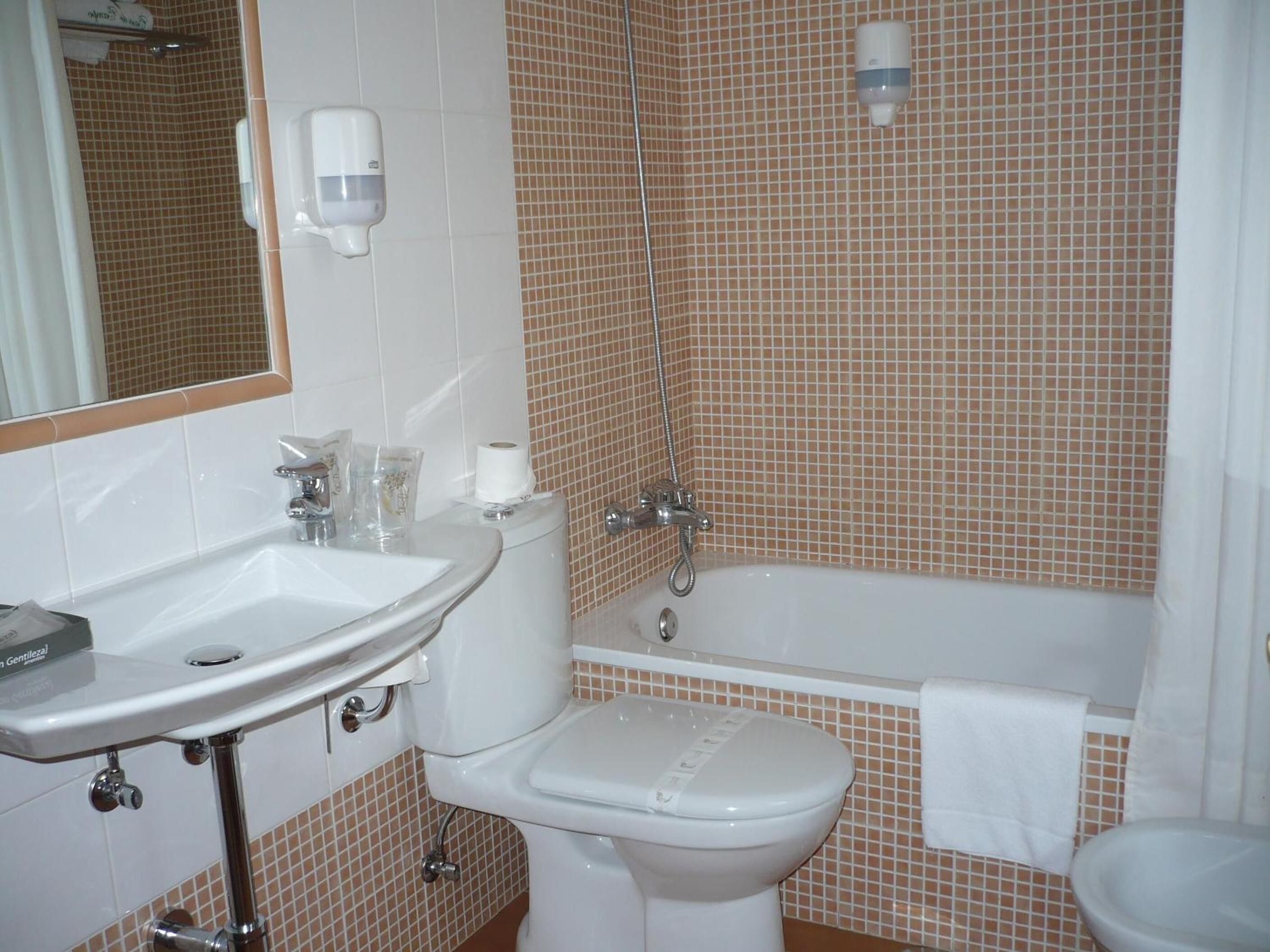 A bathroom with a sink, toilet, and bathtub.