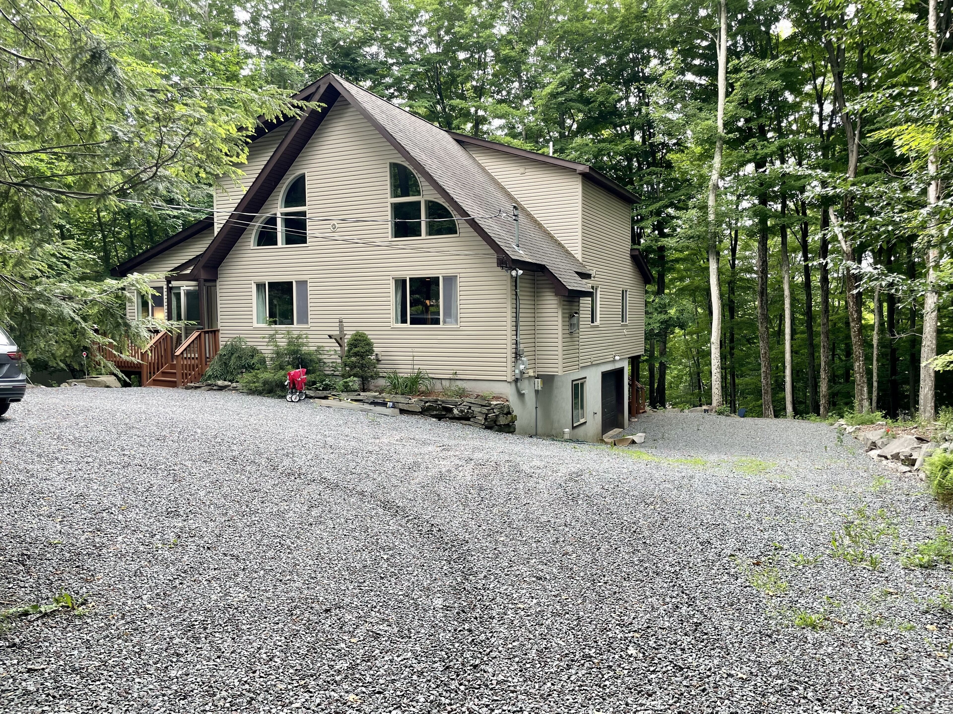 Front of our home, set back off the road, large recently traveled driveway
