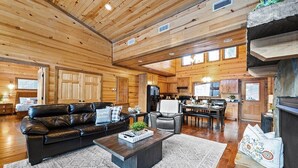 A spacious living area with a leather sofa, a coffee table, and a fireplace. - Journeys End -2 BR-Timber Creek Trails (Broken Bow)