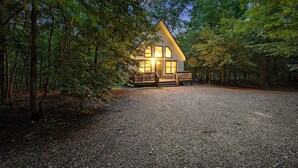 A cabin with a wooden deck, surrounded by trees. - Summer Brook Studio-Creekside-Timber Creek Trails (Broken Bow)