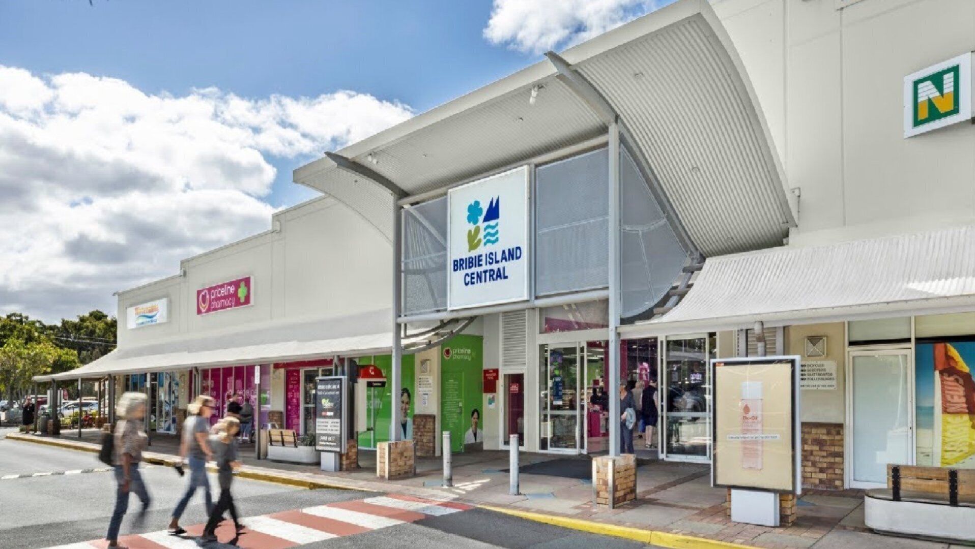A building with a sign for Bribie Island Central, a pharmacy, and a visible entrance.