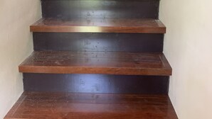 A wooden staircase with a handrail on the left, leading to an upper floor. - 3-bedroom vacation home just 20 minutes from Six Flags St. Louis (Ballwin)
