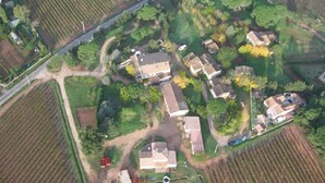 An aerial view of a residential area with multiple houses, roads, and fields.