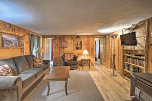 Relax in this inviting living room with a comfortable sofa, wooden coffee table, and fireplace.