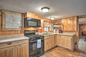 Enjoy cooking in this fully equipped kitchen with a stove, microwave, and sink.