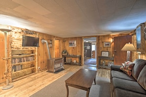 Cozy living room with a comfortable sofa, flat-screen TV, and bookshelf.