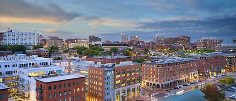 A cityscape with modern buildings, a mix of commercial and residential structures, and a clear sky.