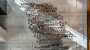 A modern lobby with a geometric wall art installation, a blue sofa with cushions, and a polished floor reflecting light. - The G Shenzhen, A Tribute Portfolio Hotel (Shenzhen)