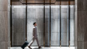 A modern elevator interior with a marble wall and metallic accents. - The G Shenzhen, A Tribute Portfolio Hotel (Shenzhen)