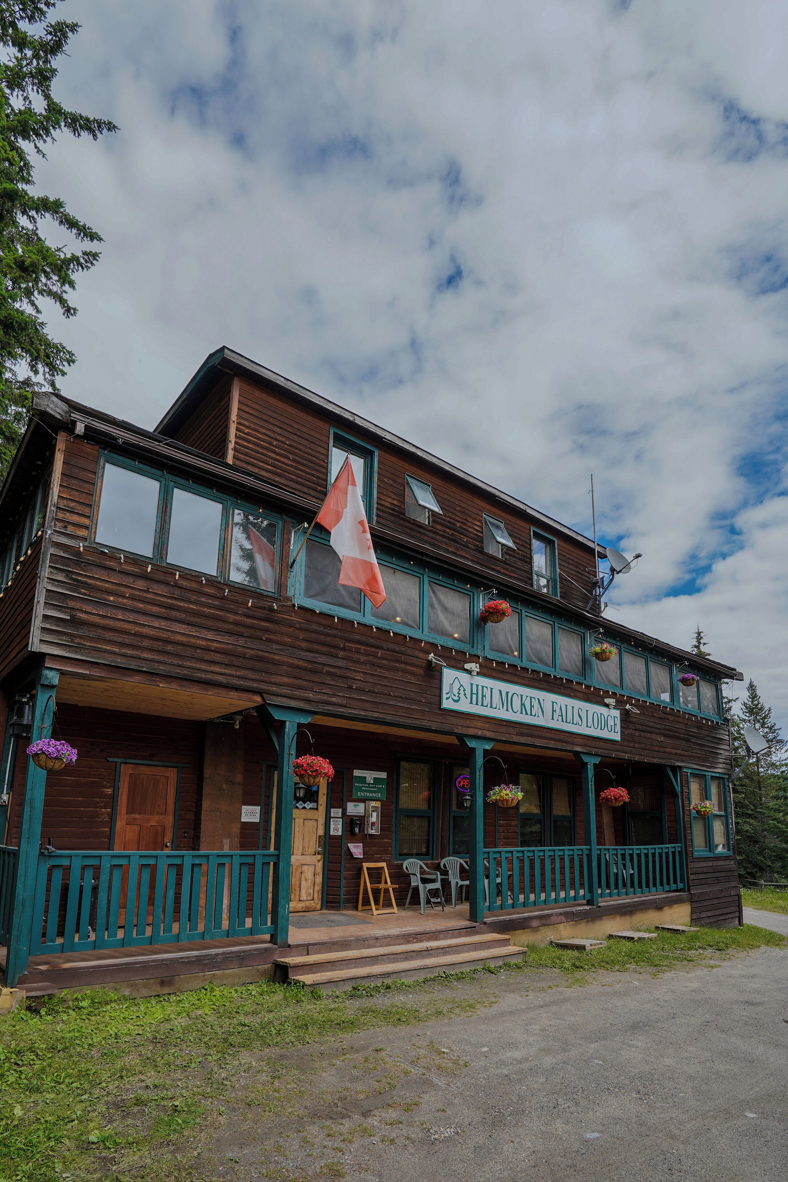 A wooden building with a sign reading "Helmcken Falls Lodge."