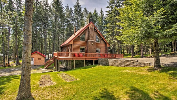 A log cabin with a red roof, a wooden deck, and a stone wall. - 'The InnLet' - Comfy Cabin By Conkling Marina (Worley)