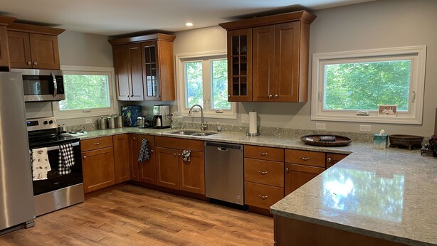 A modern kitchen with wooden cabinets, stainless steel appliances, and a granite countertop. - Berkshire Lake at the Pillow, and EV! (Otis)