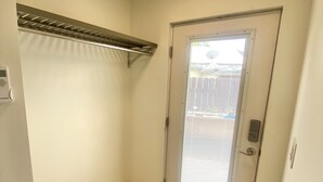 A room with a wooden floor, a door with a window, and a ceiling light fixture. - Garden Patio Studio near Bosque, Old Town (Albuquerque)