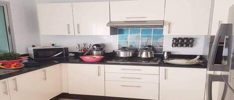 Fridge, microwave, stovetop, cookware/dishes/utensils