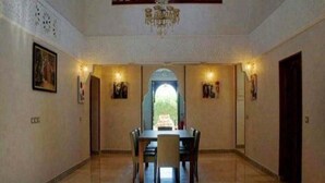A spacious dining area with a high ceiling, chandeliers, and a view through an arched doorway. - Sublime villa with swimming pool in Marrakech 4814 (Marrakech)