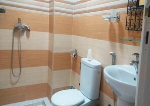 A bathroom with a shower, toilet, and sink. - Moroccan Surf Adventures 5188 (Imi Ouaddar)