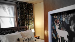 A neatly made bed with white linens and a pillow labeled "BE OUR GUEST". - Cozy 4bd - Ski Okemo, Killington, Magic & Bromley (Chester)