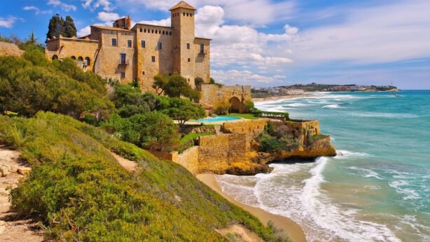 A historic stone castle with a tower, overlooking a coastal area with a clear view of the sea. - Marina Pándols by Interhome (Torredembarra)