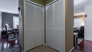 A hallway with a closed door and a chair in the background. - Single family dream in the hearth of FAIRFAX VA (Fairfax)