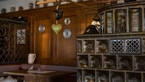 A wooden cabinet with decorative metal panels and a hanging shoe rack. - 3/4/5/7 Gamsbleame for 1-2 pers., 21 m2 (Bischofswiesen)