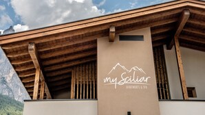 A building with a wooden facade and a sign that reads 'my Sailiar Apartments & Spa.'