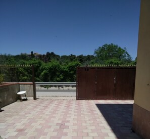 Relax on the patio surrounded by lush greenery and enjoy a quiet moment with a view.