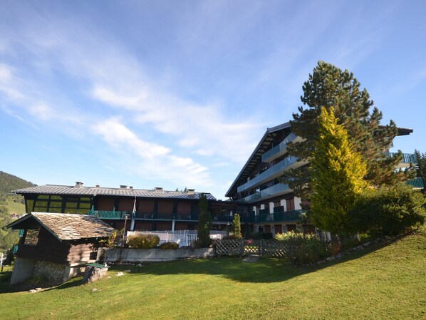 A traditional chalet-style building with multiple balconies and a wooden exterior.